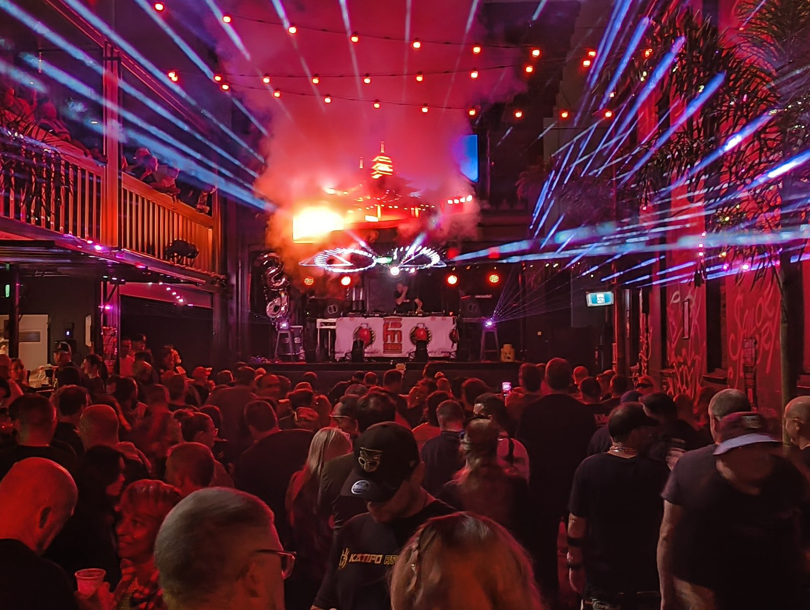 A packed floor facing the stage under lasers at Critical Mass, 2026
