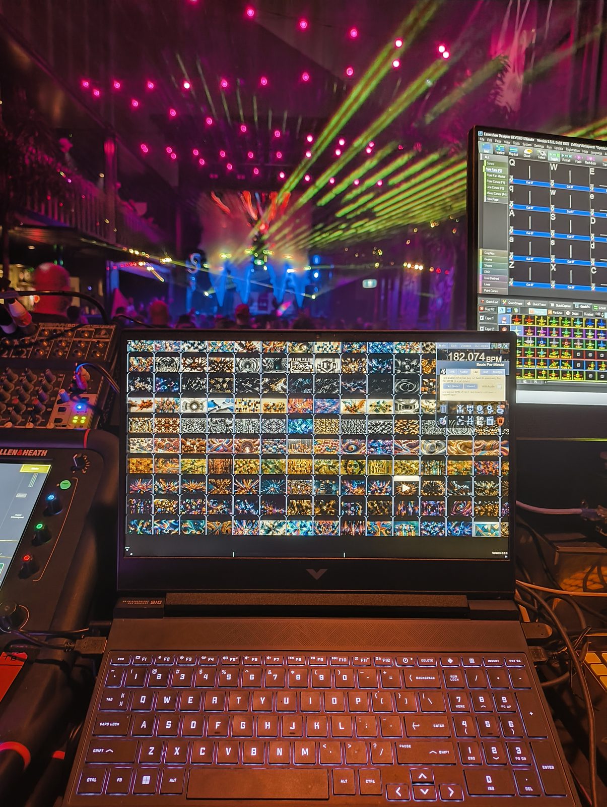 The visuals desk mid-set, lasers over the stage beyond