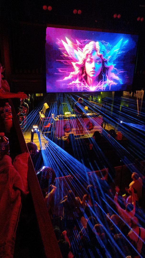 Lasers over the floor and the DJ booth, seen from the balcony