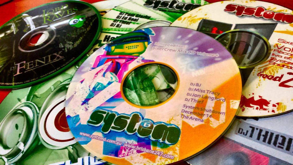 A spread of System 6 mix CDs from the Arena years